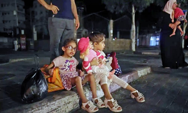 Palestinians in Gaza seen fleeing their homes Thursday night to take refuge in UNRWA schools. — courtesy Twitter