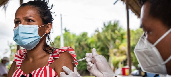 A woman is vaccinated against COVID-19 in the indigenous community of Concordia, Colombia, in this file courtesy photo. 