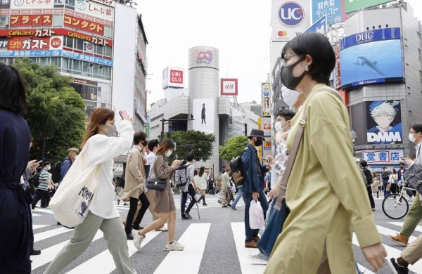 A recent photo shows people walk on a scramble crossing near Shibuya Station. — courtesy Kyodo