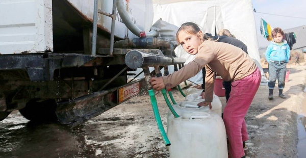 A young girl collects water from a tanker truck in an IDP camp in northwest Syria. — courtesy UNICEF/Khaled Akacha