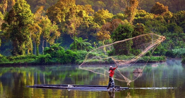 A man fishes in a forest lake in Indonesia. – courtesy CIFOR/Ricky Martin