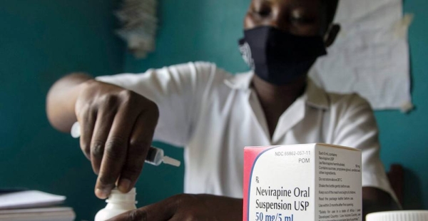 A midwife prepares medicine for a two-week-old HIV-positive baby in Uganda. — courtesy UNICEF/Jimmy Adriko