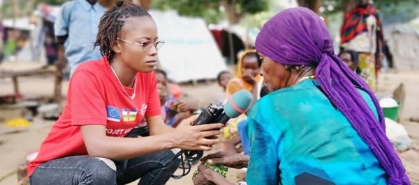 Central African reporter Merveille Noella Mada-Yayoro reporting on conditions at Birao IDP camp. for Guira FM, the UN peace mission's radio in CAR. — courtesy MINUSCA