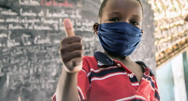 
An eight-year-old child in Nouakchott, Mauritania, gives a thumbs-up after an awareness session on preventing COVID-19. — courtesy UNICEF/Raphael Pouget