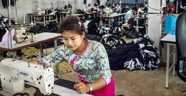 A migrant worker sews clothes in a factory in western Thailand. — courtesy UN Women/Piyavit Thongsa-Ard