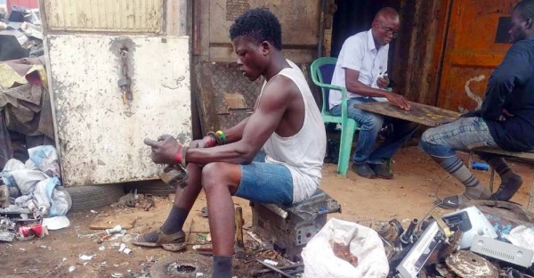 An e-waste worker disassembles items in Ghana. — courtesy WHO/Abraham Thiga Mwaura