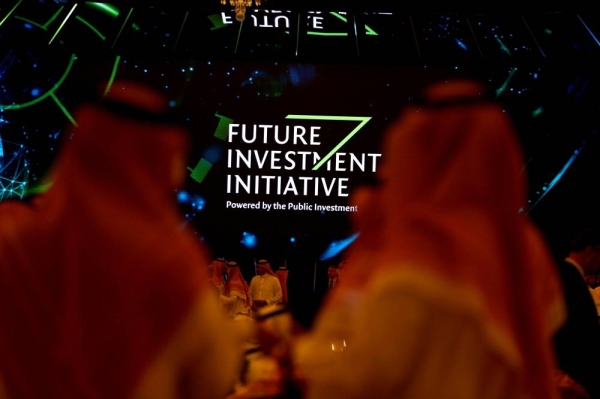 Participants look at a sign of the Future Investment Initiative during the investment conference in Riyadh, Saudi Arabia October 23, 2018. — File photo.