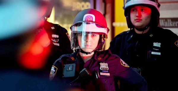 New York City Police Officers look on as protests are under way against racism and police violence after the death of George Floyd. — courtesy UN Photo/Evan Schneider