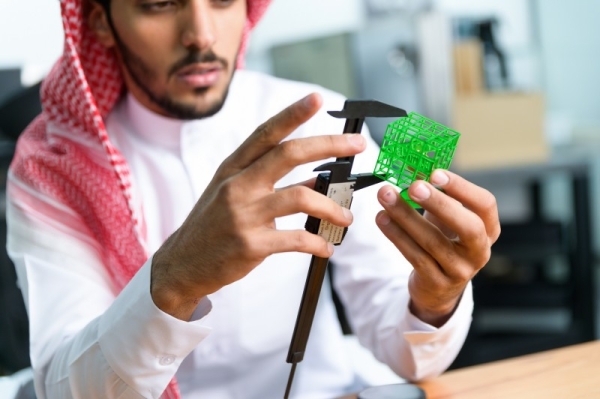 Shot of a young scientist using a microscope in a lab