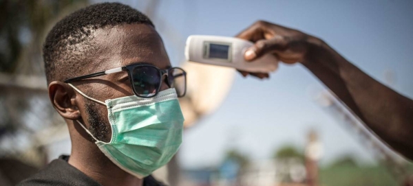 A man's temperature is taken in Mali to check against possible COVID-19 infection in this courtesy file photo.