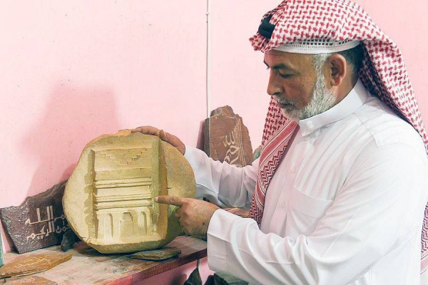 Sculptor Husban Bin Ahmad Al-Enizi from Tabuk region is sculpting the Holy Qur’an on Tabuk's stone blocks and granite.