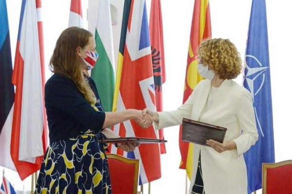 UK Ambassador Rachel Galloway, left, and the Defense Minister of North, Macedonia Radmila Shekerinska, shake hands after signing the agreement. — Courtesy photo