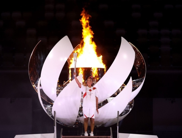 Naomi Osaka of Team Japan lights the Olympic cauldron with the Olympic torch during the Opening Ceremony of the Tokyo 2020 Olympic Games at Olympic Stadium on July 23. (Credit: twitter @naomiosaka) 