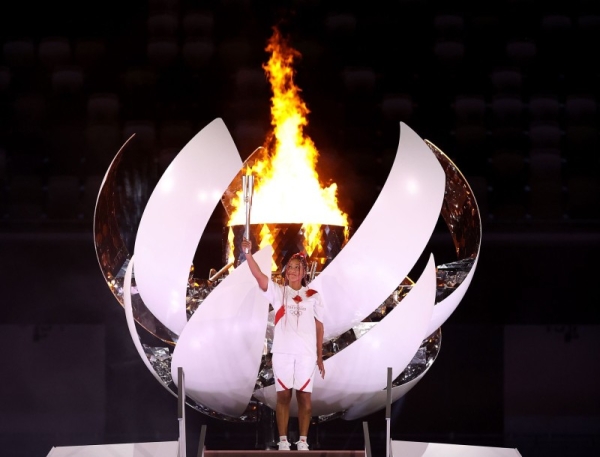 Naomi Osaka of Team Japan lights the Olympic cauldron with the Olympic torch during the Opening Ceremony of the Tokyo 2020 Olympic Games at Olympic Stadium on July 23. (Credit: twitter @naomiosaka) 