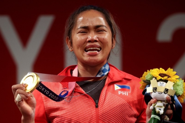Diaz burst into tears and embraced her coaches after completing the record-breaking lift. (Credit: Twitter @Olympics)