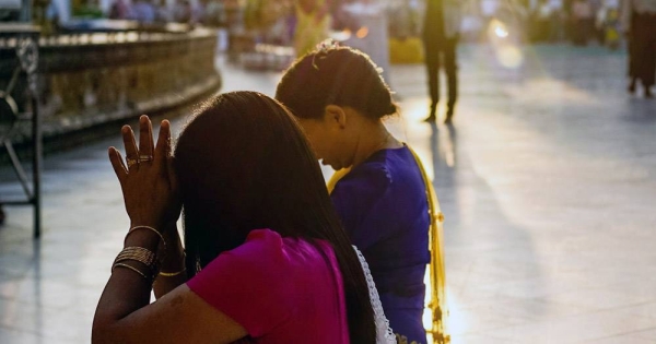 People praying in the grounds of a temple in Yangon, Myanmar, the country's largest city. — courtesy Unsplash/Matteo Massimi