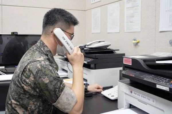 This photo, provided by the Defense Ministry on July 27, 2021, shows a South Korean service member using the inter-Korean western military communication line. — courtesy Yonhap