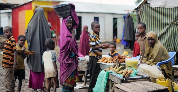 Women and children at a market stand in Kurtunwaarey, Somalia. — courtesy UN Photo/Tobin Jones