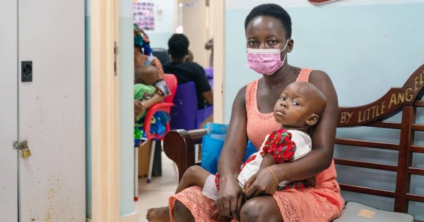 A two-year-old girl and her mother wait to see a doctor at the paediatric oncology unit at a hospital in Accra, Ghana. — courtesy WHO/Ernest Ankomah