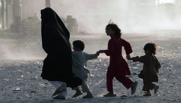 File photo of a family running across a dusty street in Herat, Afghanistan.