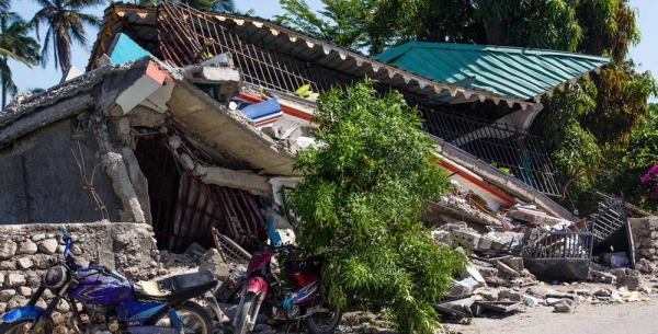A man is moved to a temporary bed while awaiting medical attention at a hospital in Les Cayes following the earthquake that struck Haiti on Aug. 14. — courtesy UNICEF/George Harry Rouzie