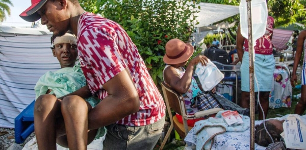 A man is moved to a temporary bed while awaiting medical attention at a hospital in Les Cayes following the earthquake that struck Haiti on Aug. 14. — courtesy UNICEF/George Harry Rouzie
