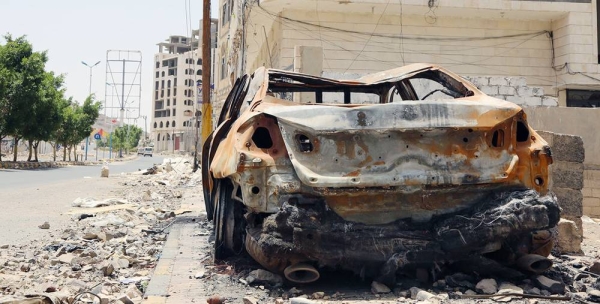 Civilians pass a burning automobile following a suicide car bombing.in Mosul, Iraq. — courtesy UNHCR/Ivor Prickett