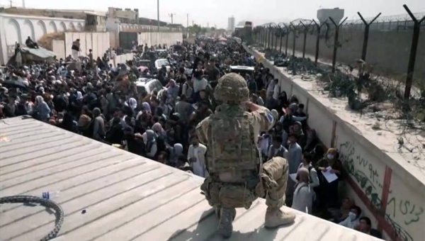 US marines provide assistance during an evacuation at Hamid Karzai International Airport in Kabul, Afghanistan, Friday.