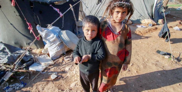 Children stand outside the tent where they live in a remote desert camp in southern rural Homs, Syria. — courtesy UNICEF/Abdulaziz Aldroubi