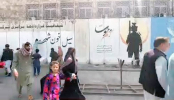 A videograb shows that the Taliban have started to work to change the face of Afghanistan with fighters whitewashing murals.
