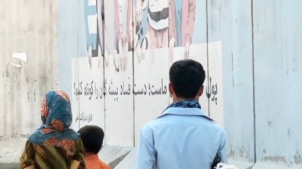 A videograb shows that the Taliban have started to work to change the face of Afghanistan with fighters whitewashing murals.