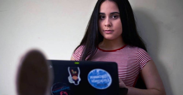 Venezuelan refugee Emily uses her laptop at home in the Ecuadorian capital, Quito. — courtesy UNHCR/ Ramiro Aguilar Villamar