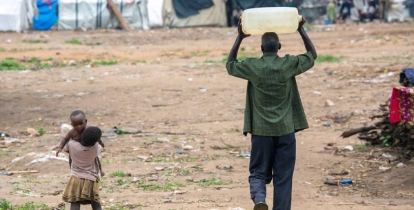 A man carries water close to Bujumbura in Burundi. — courtesy UNICEF/Karel Prinsloo