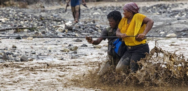People cross a flooded river in western Haiti after a bridge was washed away by Hurricane Matthew. (file) — courtesy MINUSTAH/Logan Abassi