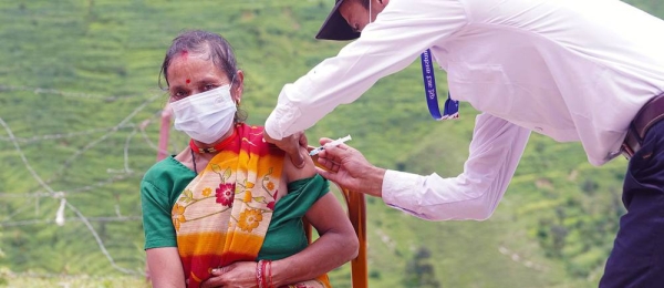 A woman is vaccinated against COVID-19 at a health post in Nepal's remote Darchula District. — courtesy UNICEF/Laxmi Prasad Ngakhusi