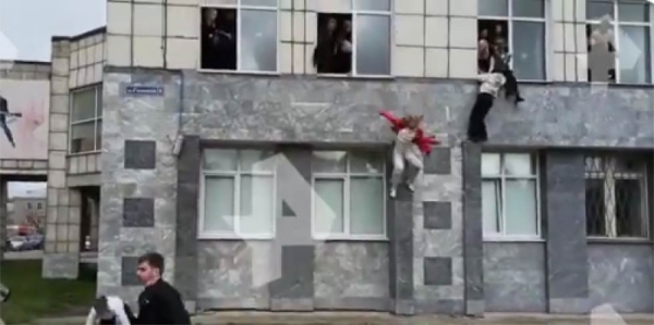 A TV grab from a footage on Russian TV shows students jumping out windows during the shooting at Perm University.