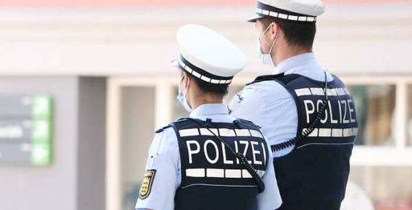 A photo of police personnel wearing masks in Germany.