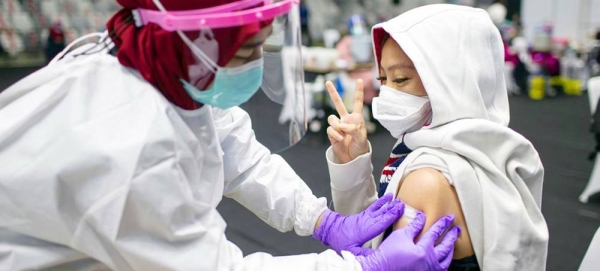 A COVID-19 vaccine is administered in Indonesia. — courtesy UNICEF/Arimacs Wilander