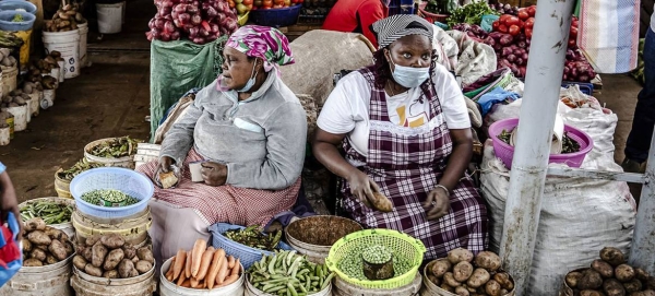 Women vendors sell fresh vegetables at a market in Limuru, Kenya.