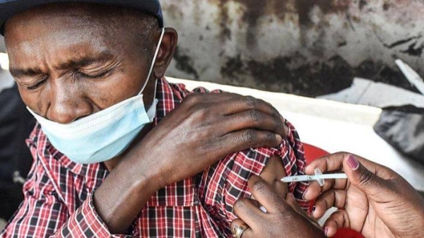 Man getting vaccinated in Kenya.