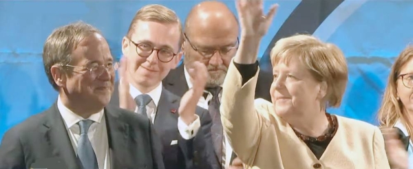Angela Merkel, whose party is scrambling to avoid defeat by its center-left rivals after a rollercoaster campaign, is seen with Armin Laschet, left, during hectic last-minute campaigning.