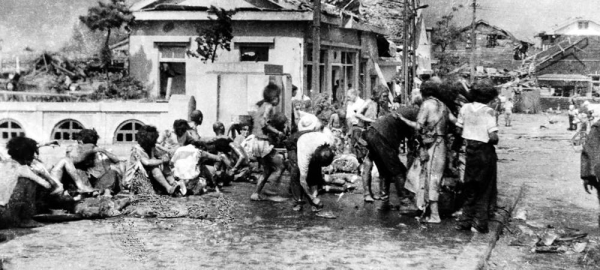 Injured civilians, having escaped the raging inferno, gathered on a pavement west of Miyuki-bashi in Hiroshima, Japan, at about 11 a.m. on Aug. 6 1945. — courtesy UN Photo/Yoshito Matsushige