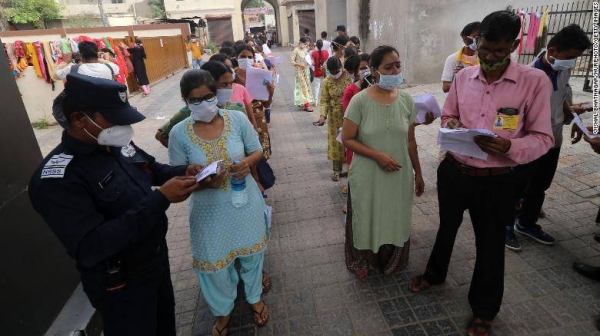 
Security personnel frisk a test candidate about to take the Rajasthan Eligibility Exam for Teachers (REET) at an examination center in Jaipur, India.
