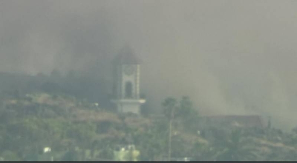A cloud of dense smoke engulfs the bell tower of the church on La Palma before it collapsed.