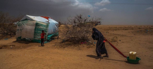 
An elderly woman drags water back to her tent in a displacement camp in Abs, near the Saudi border in northern Yemen.