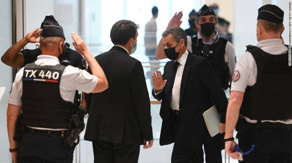 Former French President Nicolas Sarkozy (center) arrives at a hearing for the 