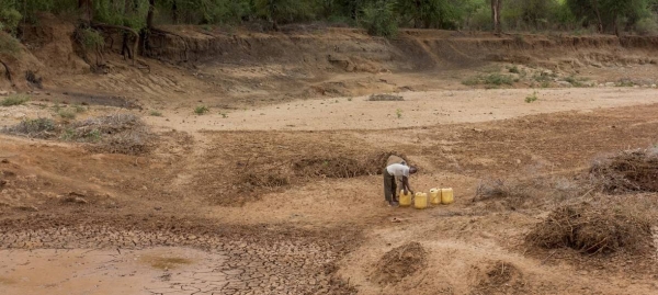 A person searches for water at a dry riverbed in eastern Kenya.