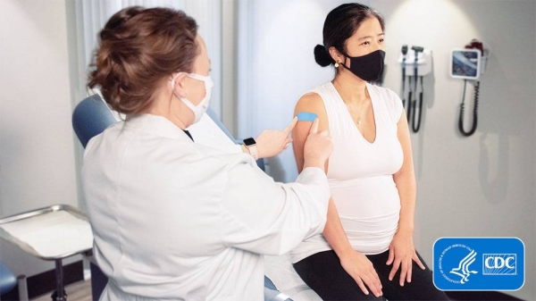 File photo of a pregnant lady getting vaccinated in US. The US death toll from COVID-19 eclipsed 700,000 late Friday — a number greater than the population of Boston.