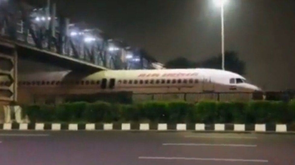 The plane got stuck under the foot-over bridge when it was being transported.