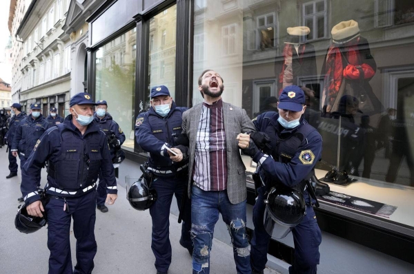 Police detain a demonstrator during a protest against coronavirus measures in the Slovenian capital Ljubljana.